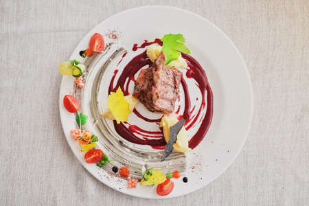 Fried lamb ribs with potato and carrots top viewの写真素材
