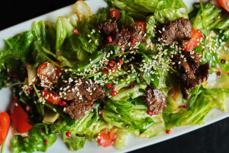 Delicious food: slow cooked pulled beef with fresh vegetable salad close-up on a plate. horizontal top viewの写真素材