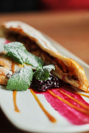 on plate of puff pastry. wooden background close-upの写真素材
