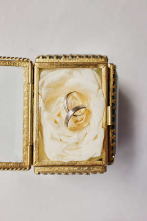 wedding rings with rose flowers, selective focus small chest