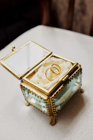 wedding rings with rose flowers, selective focus small chest