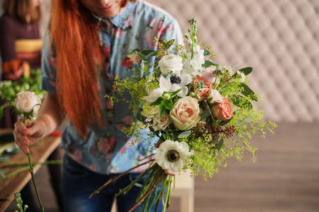 hands of florist collect wedding bouquet. florist at workの写真素材