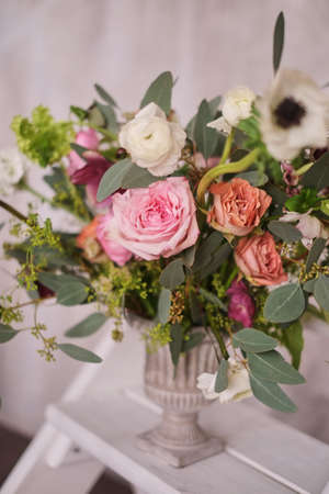 Autumn bridal bouquet of flowers stands on on the white staircase stepladder side viewの写真素材