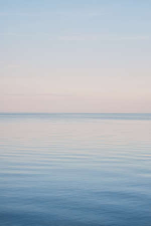 Blue sky landscape without clouds spreading on the sea in the late winterの写真素材