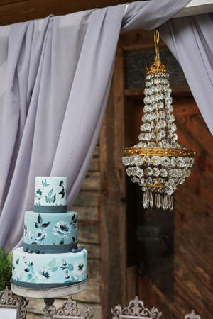 Beautiful blue three-tiered cake on the table.の写真素材