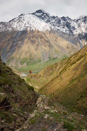 Landscape of a valley of a mountain valley, mountains with snow-capped peaks, mountain peaks,...