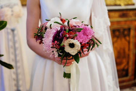 young beautiful bride in white dress holding wedding bouquet, bouquet of bride from rose cream spray, rose bush, rose purple Memory Lane, violet eustoma, eucalyptus .の写真素材