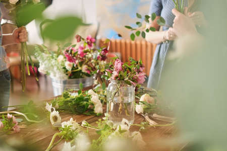 hands of florist collect wedding bouquet. florist at work