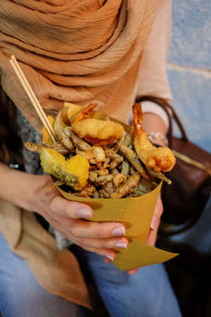 Girl holding her fast food street food seafood funnel
