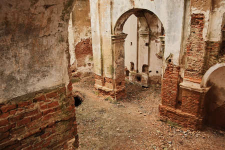 ruins of an old ruined church. red brick ruined arches