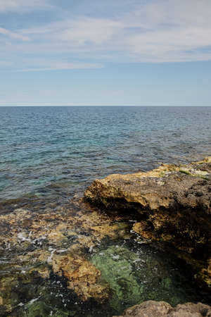 typical red and orange seascape in Mediterranean sea cliffsの写真素材