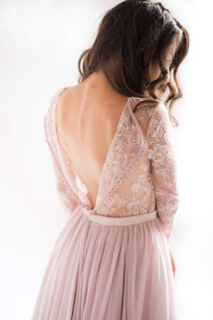 morning of the bride. the bride is standing back, studio, white backgroundの写真素材