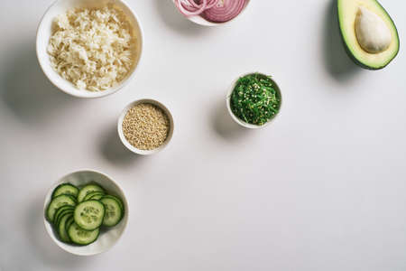 Fresh seafood recipe. Shrimp salmon poke bowl with fresh prawn, brown rice, cucumber, pickled sweet onion, radish, soy beans edamame portioned with black and white sesame. Food concept poke bowlの写真素材