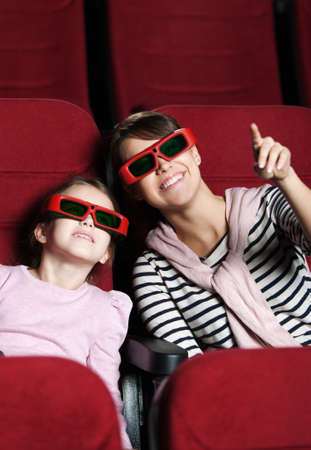 A girl with mother are watching 3D movie