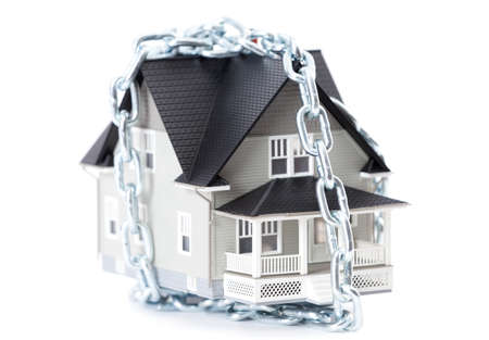 Real estate concept - chain around the home architectural model, isolatedの写真素材