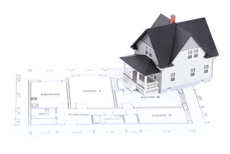 Real estate concept - construction plan with  house architectural model on it