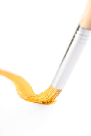 Yellow curve line drawn with paintbrush, isolated on whiteの写真素材