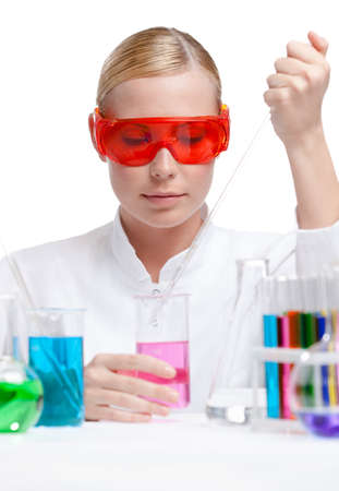 Investigator tests purple liquid in beaker, isolated on whiteの写真素材