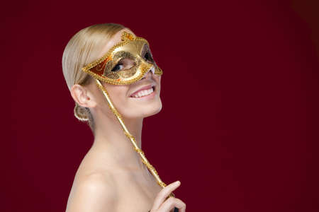 Smiley woman with masquerade mask, isolated on purple