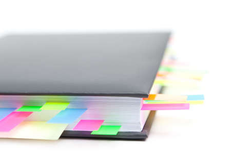 Business diary with a colored tabs, isolated on white backgroundの写真素材