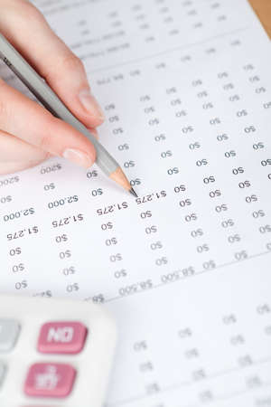 Close up view of hand writing in the document with pencilの写真素材