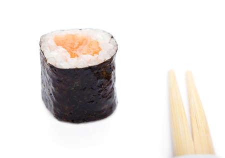 Maki roll with chopsticks, isolated on whiteの写真素材