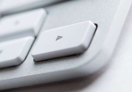 Part angle with arrow key of light laptop keyboard