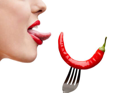 Close up of woman's tongue and capsicum on stainless fork, isolated on whiteの写真素材
