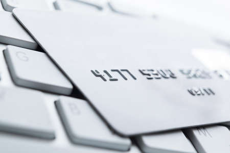Close up of credit card on a pc keyboard. Concept of internet buying