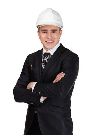 Smiley businessman in white helmet with arms crossed, isolated on white