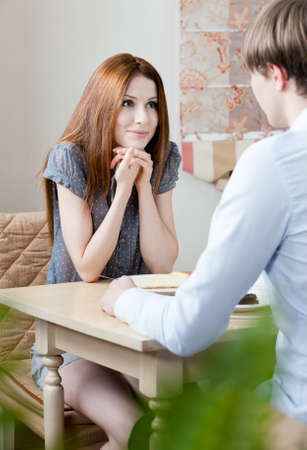 Lovers talk sitting at the table at the barの写真素材