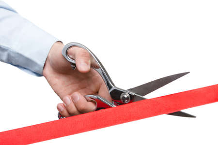 A man cutting a ribbon with scissors, isolated on whiteの写真素材