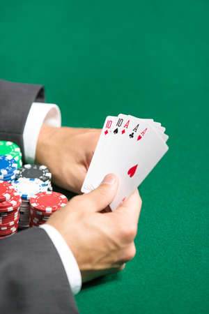 Gambler with full house on hands. Addiction to the gambling