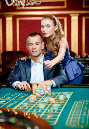 Woman advises gambler a safe bet. Risky entertainment of gamblingの写真素材