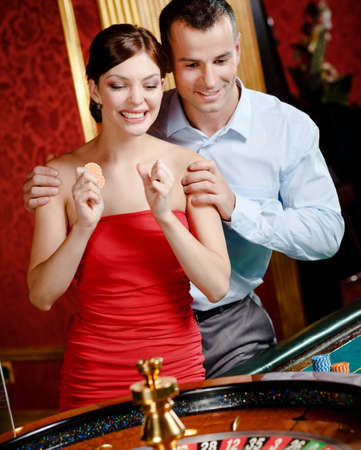 Couple playing roulette follows the game at the casinoの写真素材