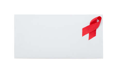 Envelope with red ribbon. Symbol of aids awareness, isolated on whiteの写真素材