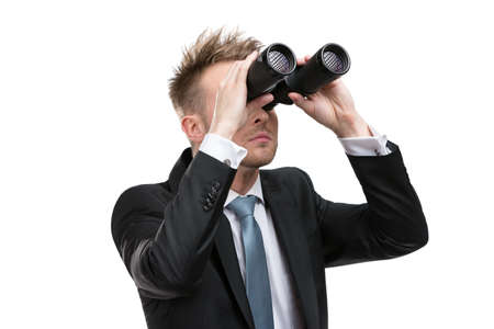 Business man wearing suit with blue tie hands binoculars, isolatedの写真素材
