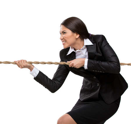 Businesswoman pulls the rope, isolated on white. Concept of competition and job competitive promotionの写真素材
