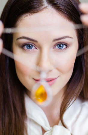 Woman handing necklace with yellow sapphire at jeweler's shop. Concept of wealth and luxurious life