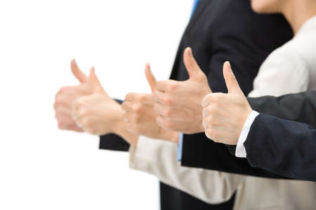 Close up of thumbing up hands, isolated on white background. Concept of teamwork and cooperation