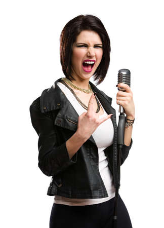 Half-length portrait of rock musician wearing leather jacket and keeping static microphone, isolated on white. Concept of rock music and raveの写真素材