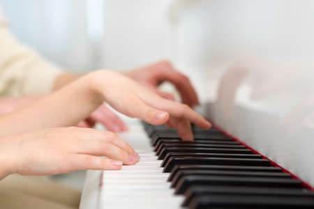 Close up of hands playing piano. Concept of music and artsの写真素材