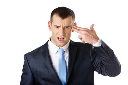 Disappointed manager shows hand gun gesture, isolated on whiteの写真素材
