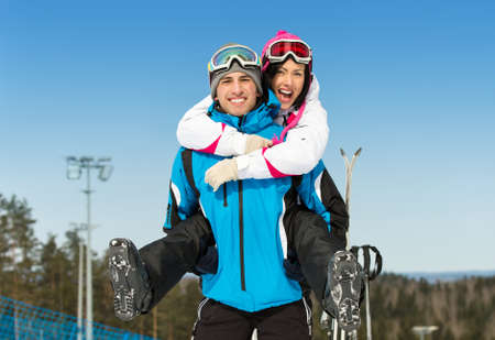 Half-length portrait of happy couple of skiers have fun. Concept of winter sports and cute vacationsの写真素材