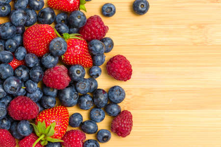 Close up of heap of berries on the table, isolated. Concept of healthy eating and dieting lifestyleの写真素材