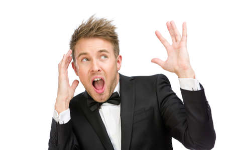 Half-length portrait of scared and screaming business man with hands up, isolated on whiteの写真素材
