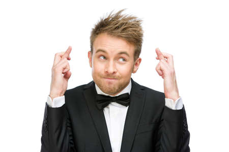 Half-length portrait of business man with fingers crossed, isolated on whiteの写真素材