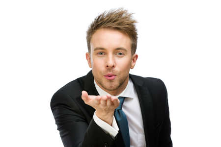 Half-length portrait of business man blowing kiss, isolated on white. Concept of love and affection