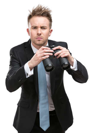 Businessman wearing suit with blue tie hands binocular, isolated on whiteの写真素材