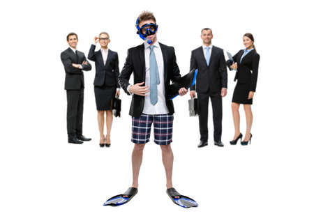 Full-length portrait of businessman wearing fins, snorkel and goggles handing folder with documents and standing against group of executives, isolated on whiteの写真素材